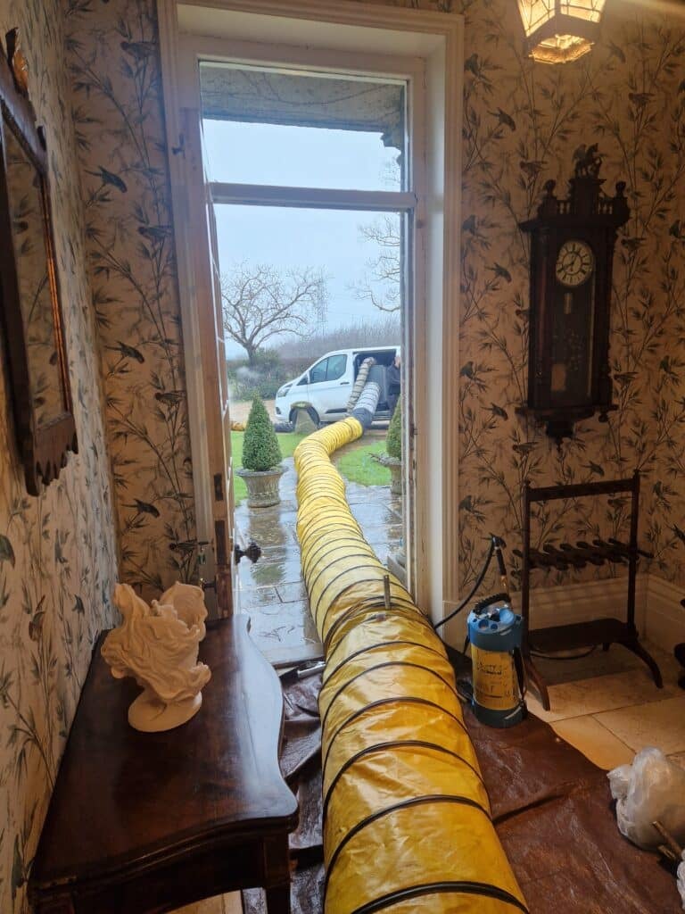 Heat treatment ducting running through a doorway into a home during a bed bug heat treatment
